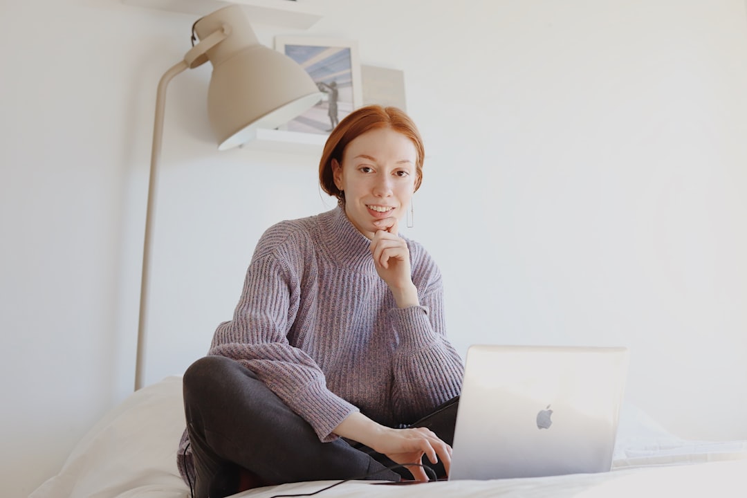 Woman sitting with a laptop, thinking